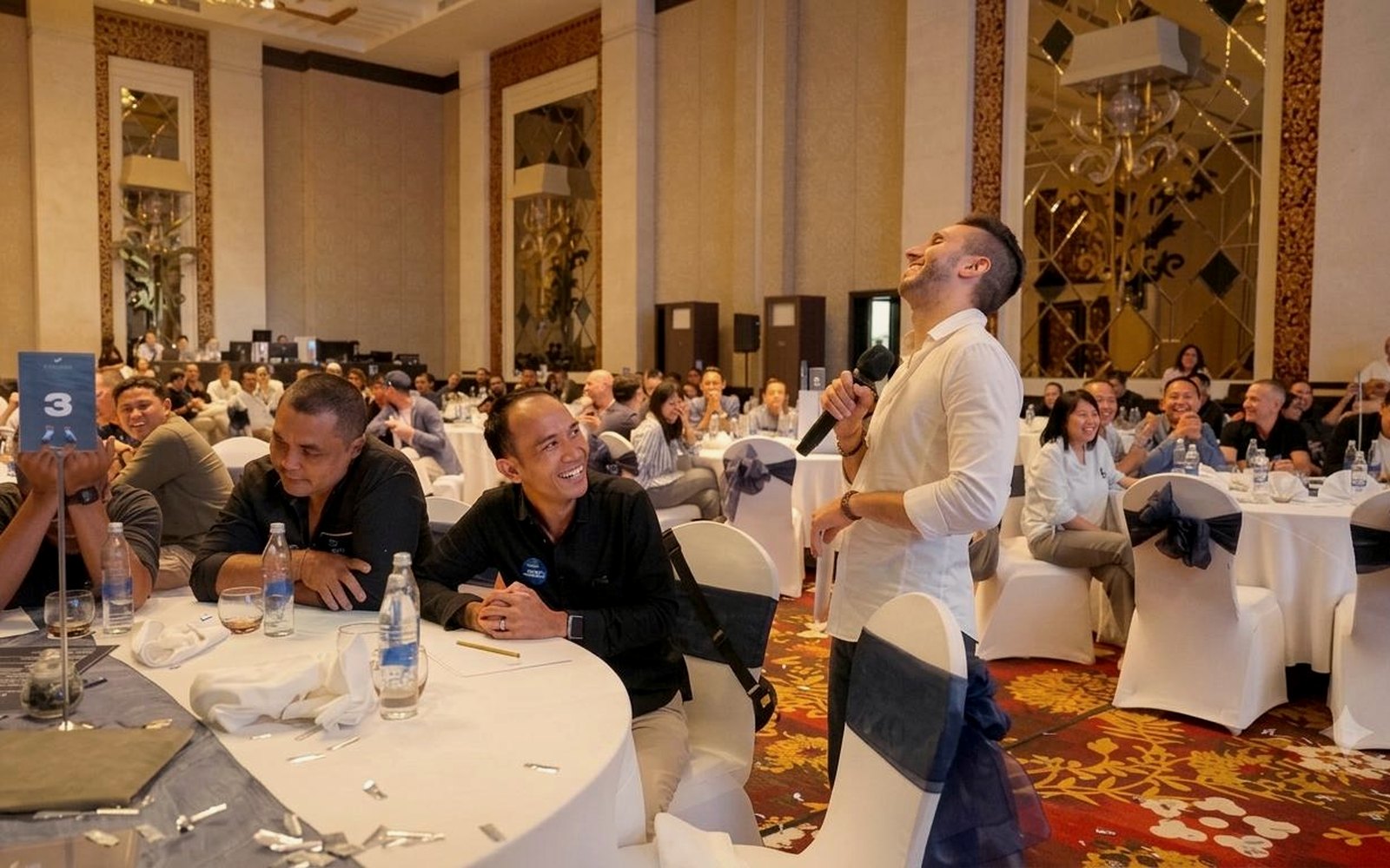 Cal Amir with a full room laughing during a workshop